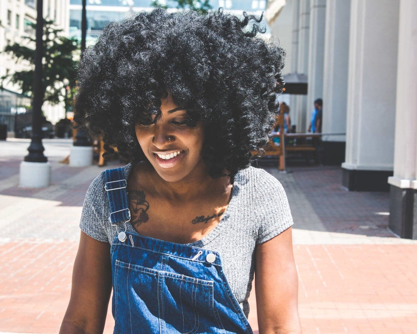 A Brooklyn neighbor smiling on her block